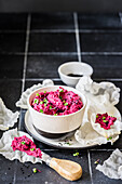 Beetroot hummus with black sesame seeds, radish micro greens and puffed rice paper