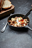 Mushroom and cannellini beans dish with a poached egg