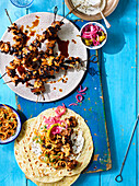 Chicken skewer tortillas, with red onion and pickles