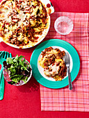 Baked ravioli with bolognese sauce and a side salad