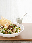 Pilaf with lamb meatballs and peas
