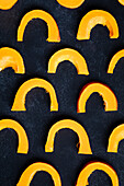 Pumpkin wedges on a black background