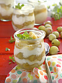 Curd cream with gooseberry groats in jars
