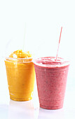 Strawberry smoothie and mango smoothie in to-go cups