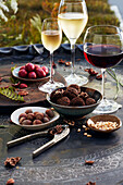Wine and nuts on a table outside