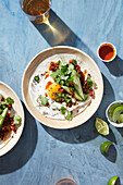 Soft shell tacos topped with a fresh egg and cilantro