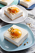 No-bake cheesecake with peach halves and transparent jelly that looks like a fried egg
