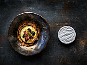 Baked Camembert with duck and plums