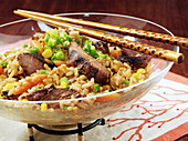 Pork Fried Rice in a glass bowl with chopsticks