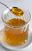 A jar of honey with a spoon (close-up)