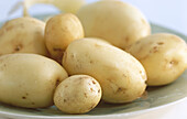 Organic potatoes on a white plate (close-up)