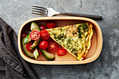 Salmon frittata served with cucumber and tomato salad