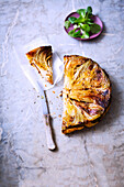 A round puff pastry tart with chicory and cumin