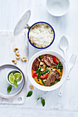 Duck cooked with a red curry sauce and vegetables served with rice