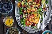 Salad with halloumi, fruit, and avocado
