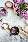 Purple lilac flowers with sugar in a bowl