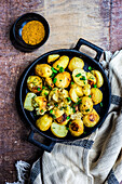 Seasonal potato vegetables roasted in the pan and served with fresh green onion and dill herb