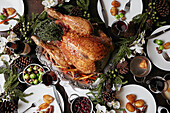 Christmas table setting featuring a large turkey