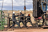 Well service crew on a workover rig