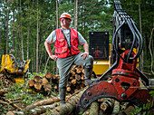Forestry worker next to machinery
