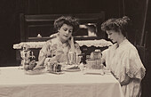Women seated at breakfast table with electric appliances