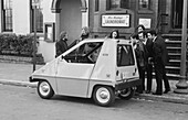 People looking at an electric car, 1974