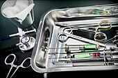 Scissors and syringes in an operating theatre