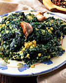 Wild spinach with eggs, garlic, and cheese (Italy)