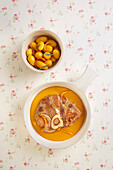 Horse osso buco with orange sauce and potatoes