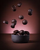 Chocolates falling into a bowl