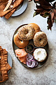 Breakfast tray with bagels, cream cheese, onions, salmon and capers