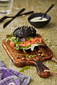 Black burger bun with fresh salmon