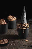 Chocolate ice cream with black waffle cone