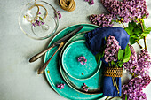 Spring tablecloth with purple flowers on a concrete table