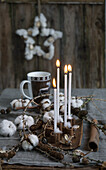 Four candle sticks in cinnamon sticks with larch twigs and cotton, coffee cup with deer motif