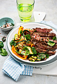 Beef with yellow bell pepper, and thyme, served with zucchini salad