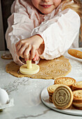 Girl preparing Easter biscuits