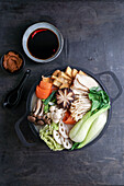 Hot Pot with napa cabbage, mushrooms, and cooked in a creamy and savory soy milk broth