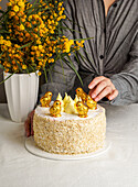 Easter cake and yellow mimosa, with chocolate chickens