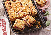 Plum cake from the tray with crumble topping