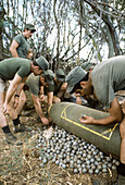 US air force members familiarizing themselves with a bomblet