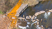 Orange iron oxide staining in stream, aerial photograph