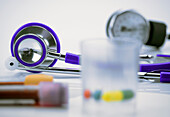 Stethoscope and vaccine vials in a hospital, conceptual image