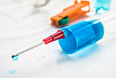 Syringe with drop of medication on the needle