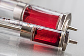 Vintage syringes containing red liquid