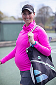 Pregnant woman on tennis court