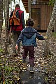 Father and son returning to cabin after hike