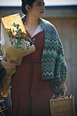 Woman with picnic basket and bouquet of flowers