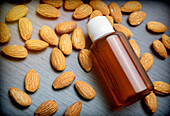 Essential almond oil on a wooden table