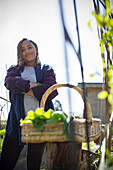 Woman harvesting vegetables in garden